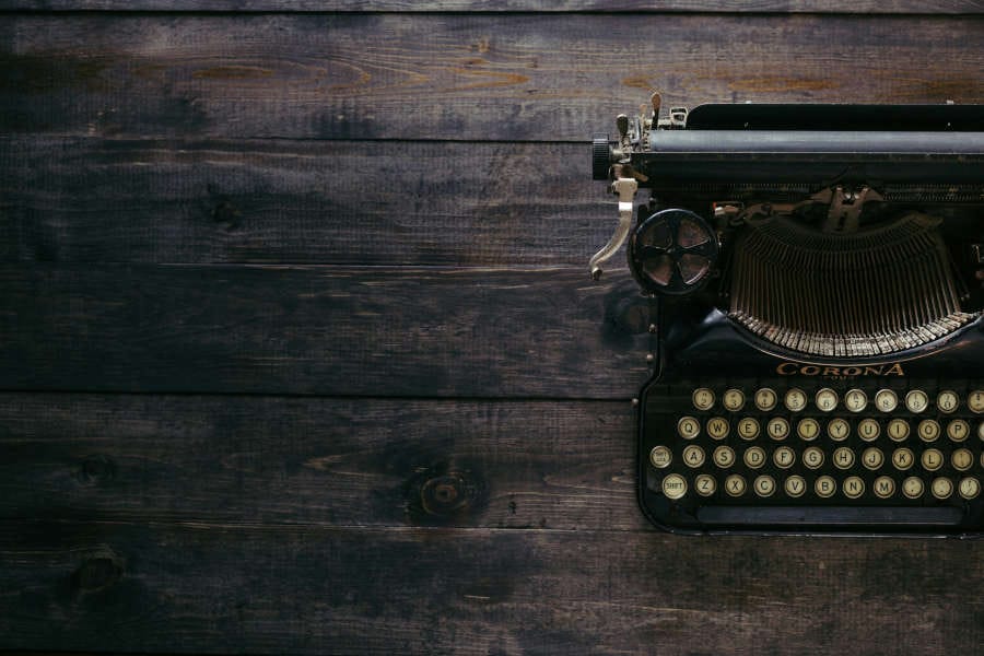 manual typewriter on wooden desk